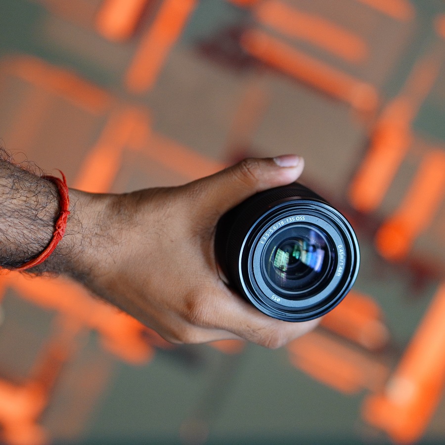 A camera lens on an orange background