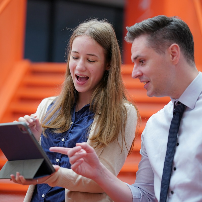 Two business owners review revenue forecasts