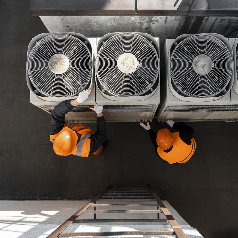 two men installing factory equipment
