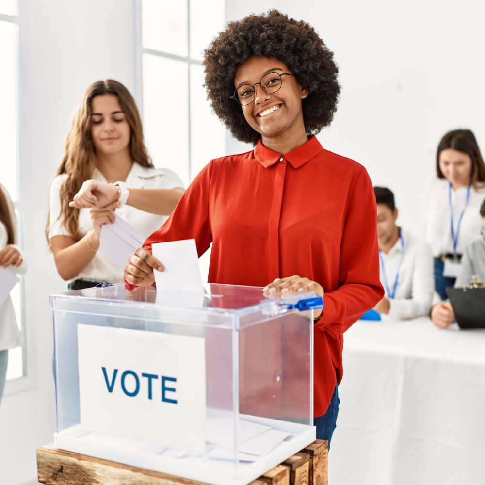 A young black woman casting her vote in the general election
