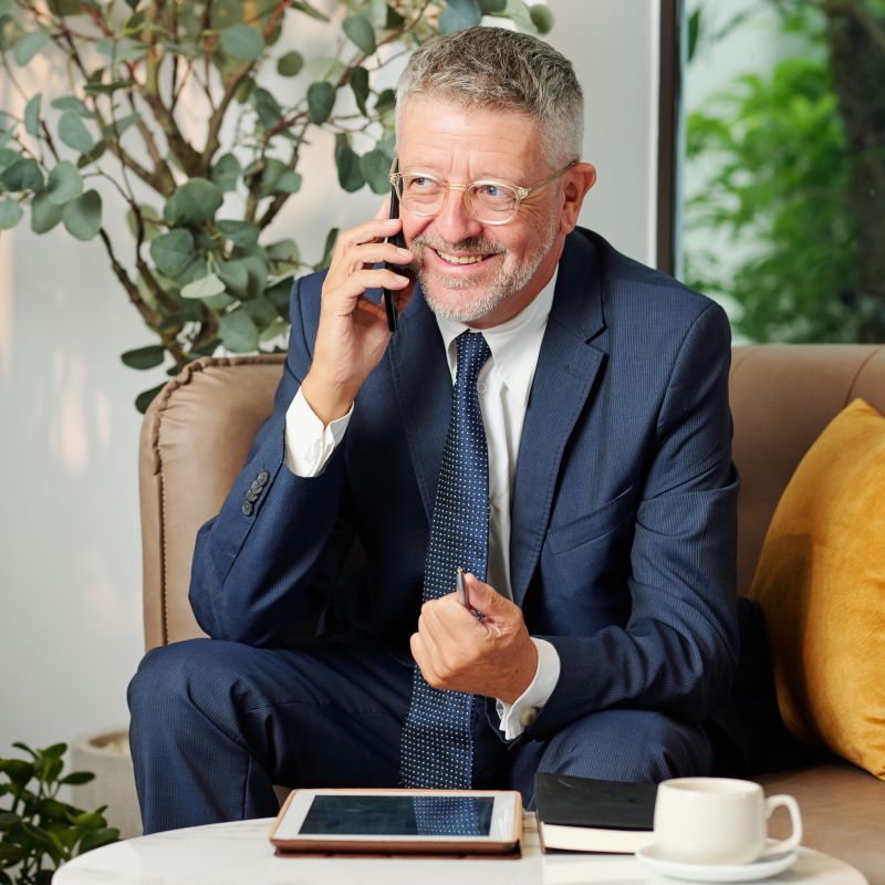 A man discusses his client's funding outcomes on the telephone