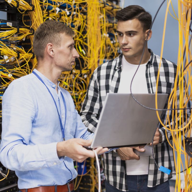 Engineers from an IT company review the server set up at a client
