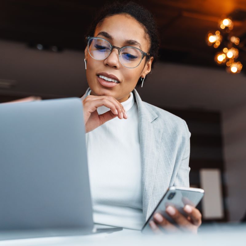 A Black female business owner reviews loan rates online