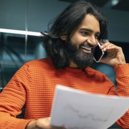 A south asian man receives good funding advice over the phone.